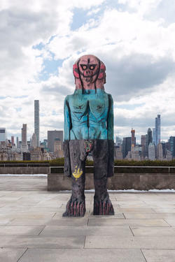 Sculpture of a giant blue and pink figure on the roof of the Metropolitan Museum of Art in New York.