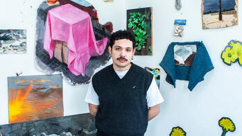 Benjamin Carrasco standing in front of his work