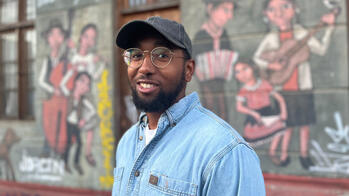 Headshot of Charlston Britton in font of a mural