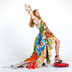 a model wears a colorful patchwork coat and pants set designed by Zoe Grinfeld
