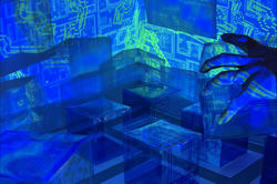moody blue image of a hand manipulating model buildings