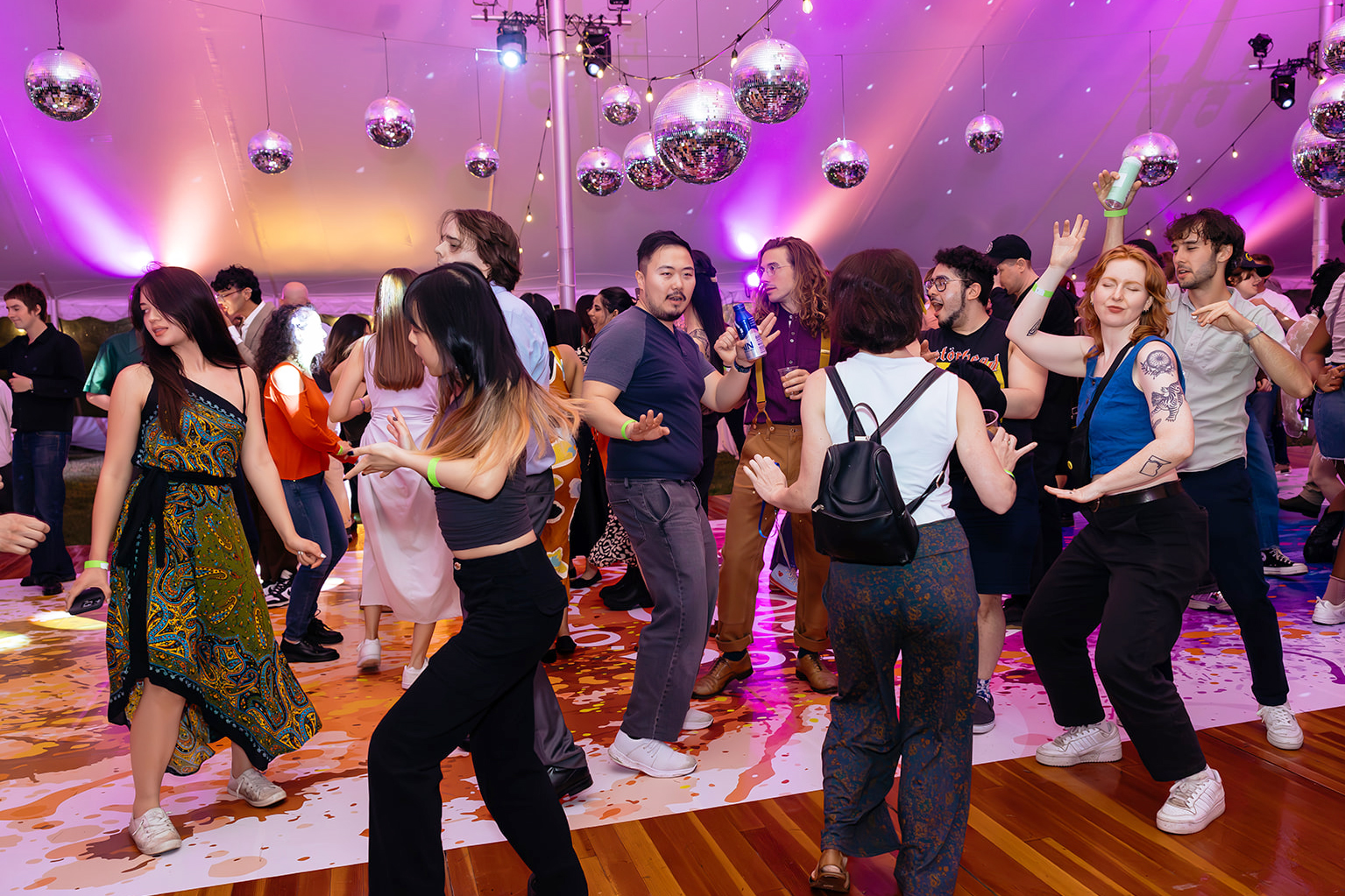 alums dancing under purple lights at artist party 2024
