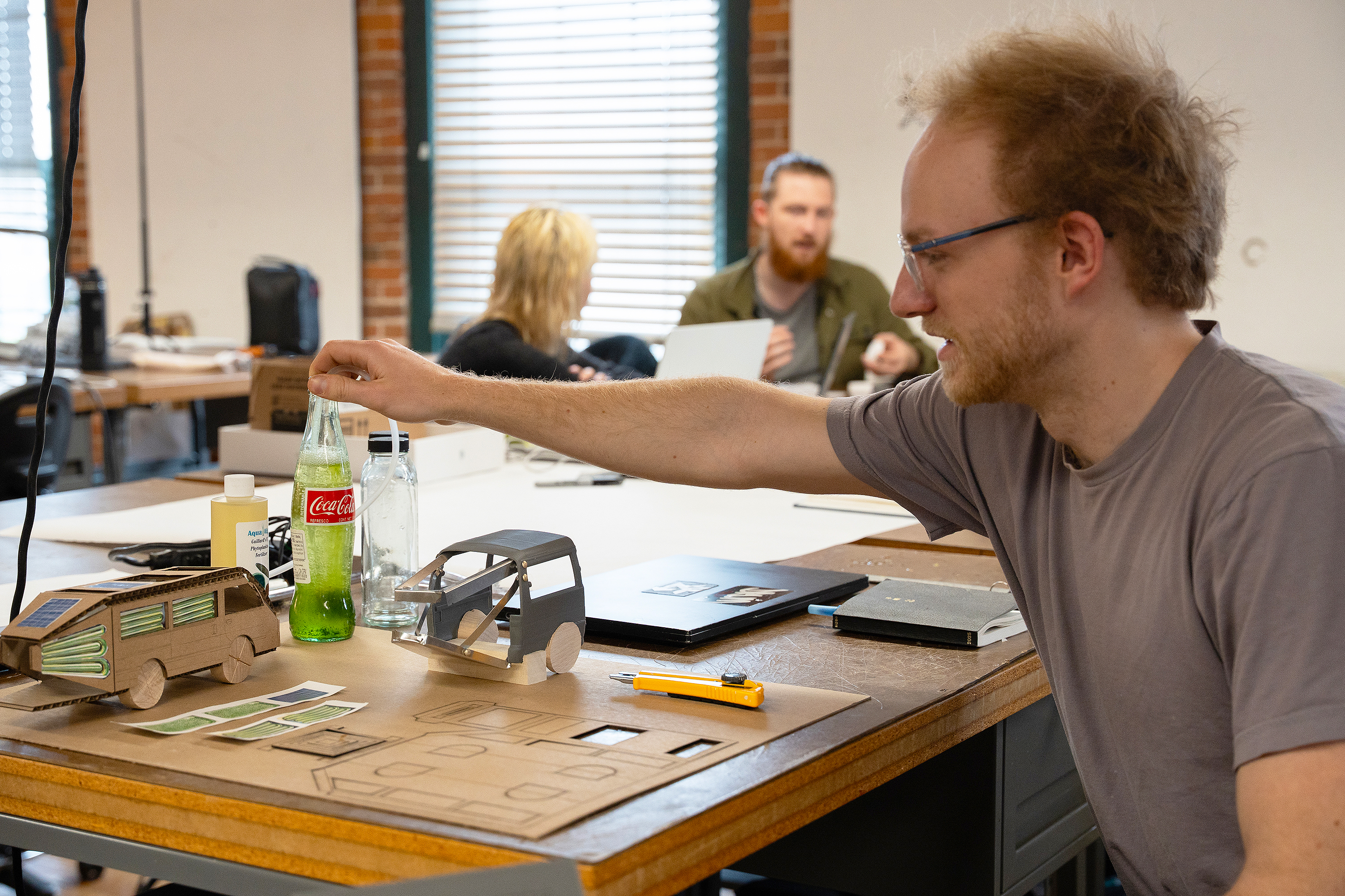 senior Gresh Chapman discusses his Coke-bottle algae farm