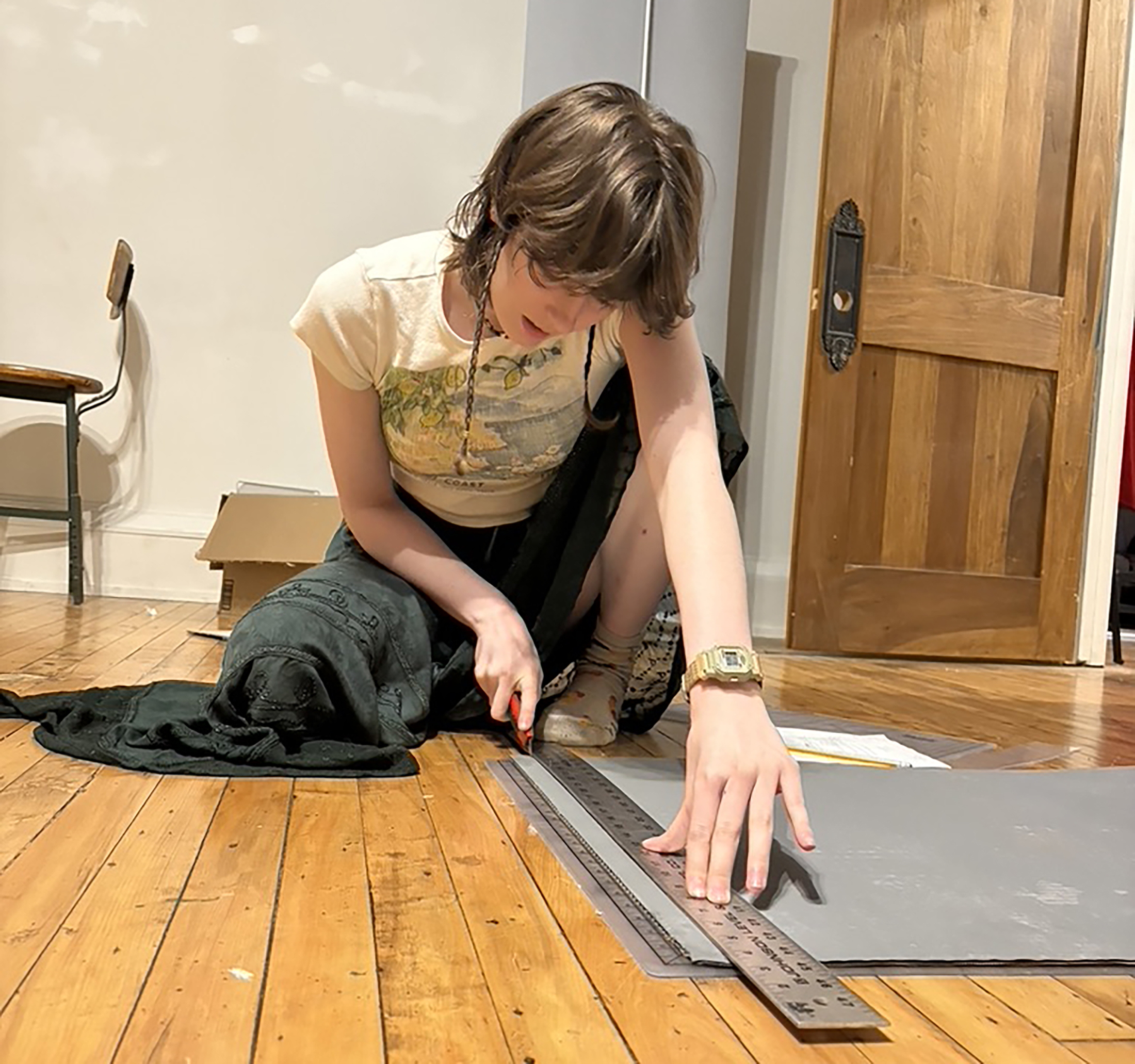 Channing Christ uses a rule and exacto knife