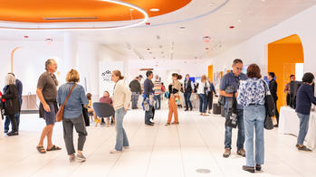 group of people spread throughout a bright room