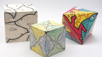 three colorful paper Escher polyhedrons