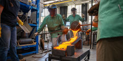Student pour molten glass onto slanted blocks