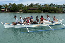 students travel by bangka, a traditional Filipino outrigger canoe