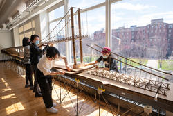 students work together on a 3D model of the bridge