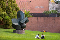 students laying on grass at risd beach