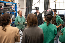 Students in gather to hear from the professor in the RISD hot shop