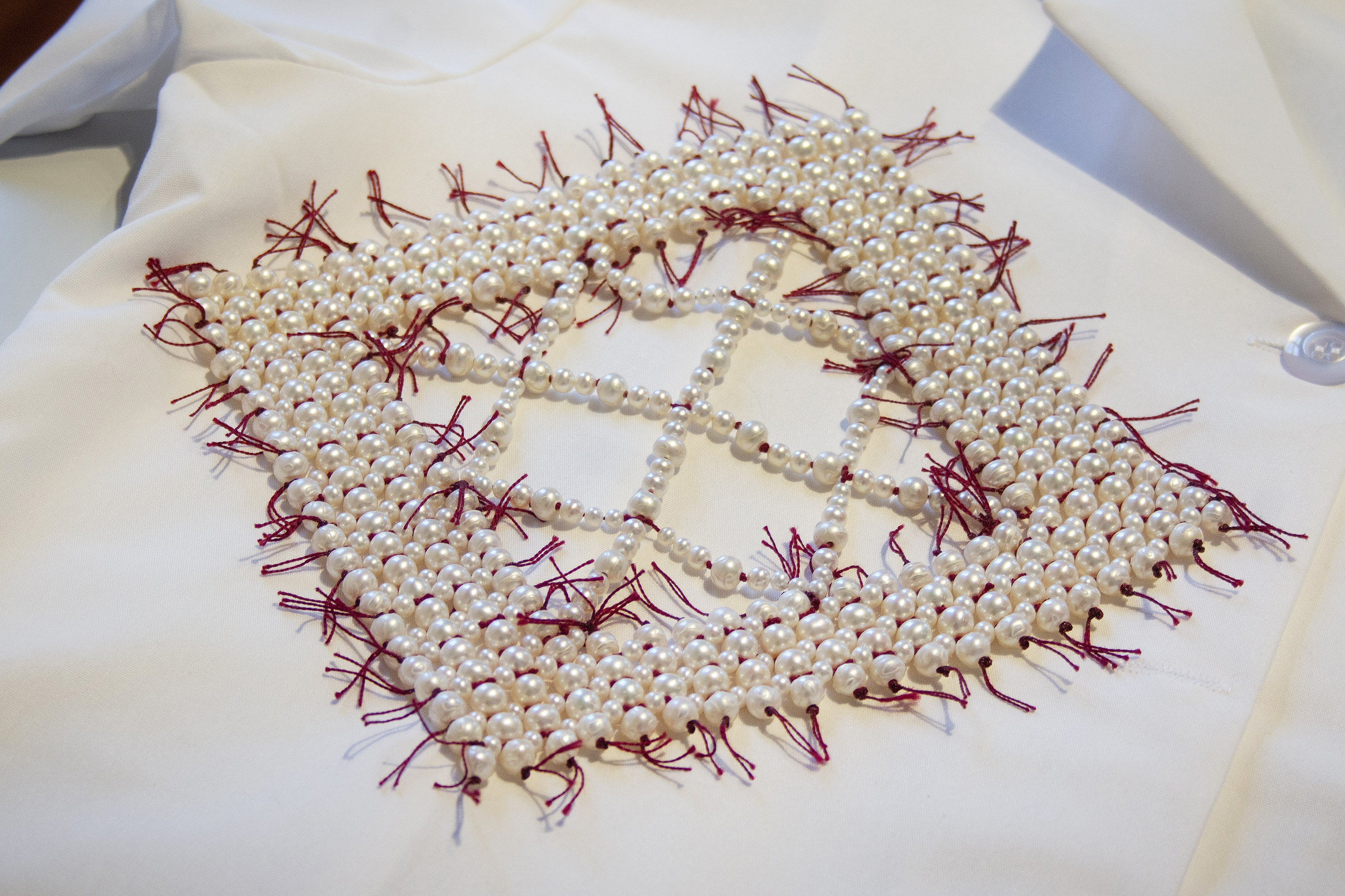 a handkerchief woven together with natural pearls