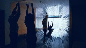 students interact with a light installation