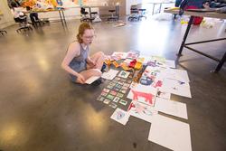 First-year arranging illustrated cards on floor