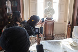 students photographing a sculpture